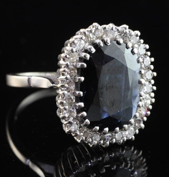 An 18ct white gold, sapphire and diamond cluster ring, size P.